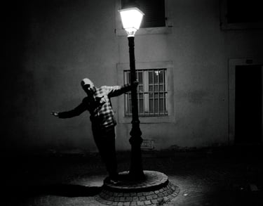 a man standing on a street light pole