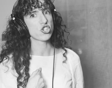 photo en noir et  blanc de aude fy en train de chanter avec casque sur les oreilles