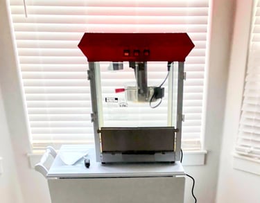 a popcorn machine on a cart