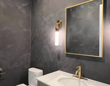 Moody black limewash bathroom with a textured matte finish, creating a sophisticated and modern spa-