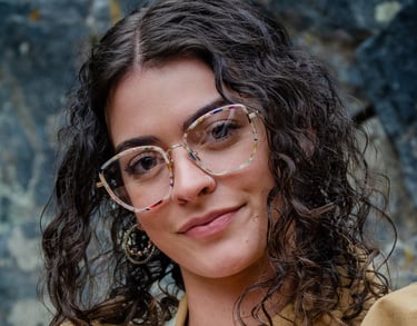 Woman wearing fashionable eyeglass frames, smiling
