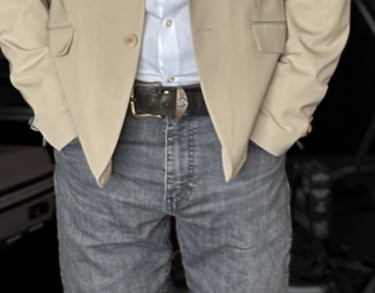 Portrait photo of Mark Murfitt wearing a cream colored jacked, white shirt, black jeans