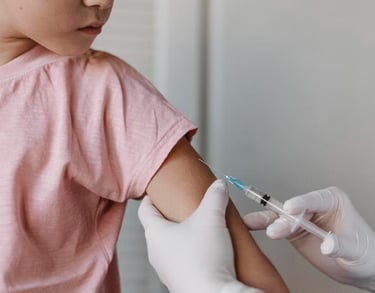 Dra Isis Pediatra administra una inyección de vacunación en el brazo a niña