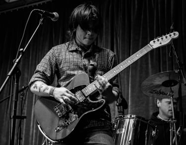 luneward live musician playing a Fender Telecaster electric guitar during a live performance.