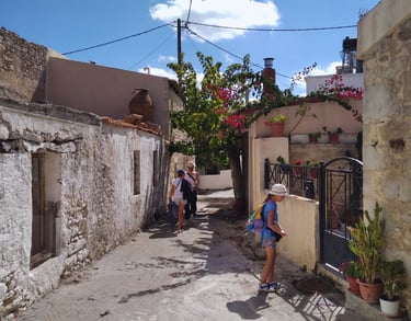 People strolling through the charming village of Alagni, surrounded by traditional stone houses.