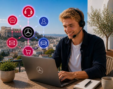 A smiling man using a Mercedes-Benz laptop and headset for remote customer support in Athens.