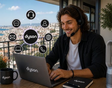 Dyson customer service agent with headset working on a laptop on a balcony with city views.