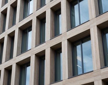 A detail shot of modern office architecture in Northern Europe, focusing on clean lines, light wood, and blue-tinted glass, symbolizing structure and clarity.