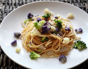 a plate of pasta with purple cauliflower and broccoli