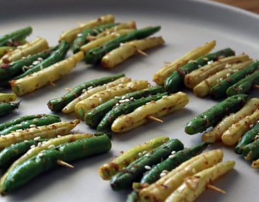 a plate of grilled yellow and green beans