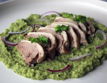a plate of aromatic salted duck with broccoli puree