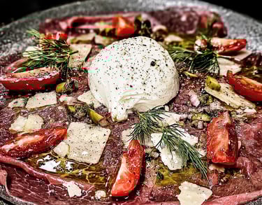 a plate with cheese and tomatoes on a plate