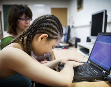 blind girl on laptop using apple accessibility settings voiceover screen reader for the disabled