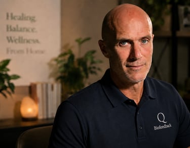 A portrait of a male biofeedback specialist in a wellness office with plants and warm lighting.