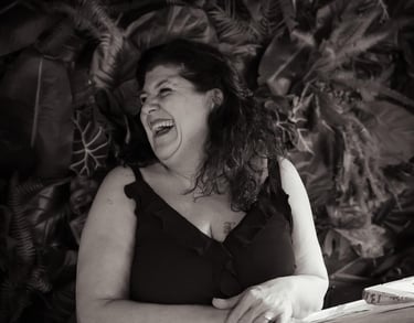 a woman in a black dress is laughing and laughing