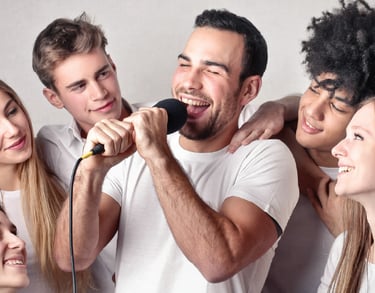 Group enjoying a karaoke system rental in Dubai with wireless mics.
