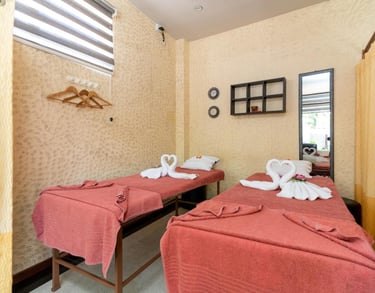 two beds in a room with towels and towels