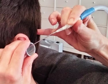 man having ear wax removal with microsuction