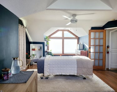 Cozy treatment room with soft lighting and a massage table prepared for a session.