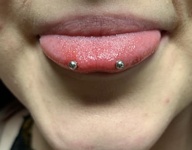 a woman with a snake eyes piercing