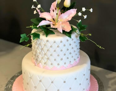 Elegant celebration cake decorated with refined details, available in chocolate or vanilla perfect for birthdays, weddings