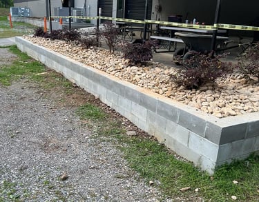 retaining wall holding rock and plants