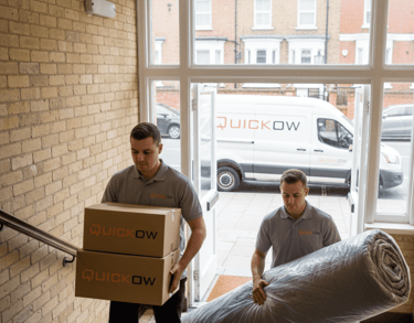 Quickow removal team with branded packing boxes during a house move.