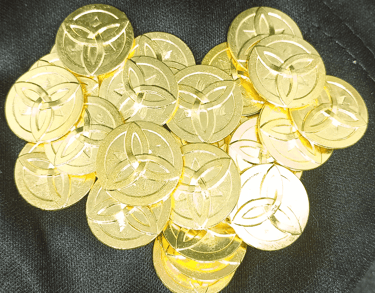 a pile of Nordic rune marked golden coins on a black background