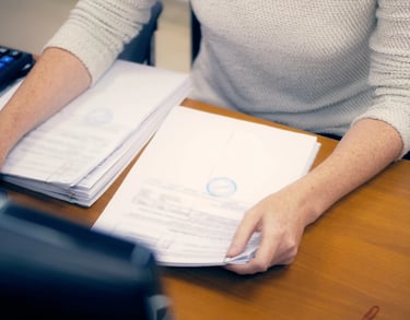 a woman sitting at a desk with a calculator