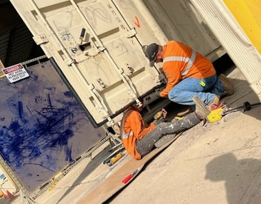 Technicians working on a container preforming service work for a mobile service call.