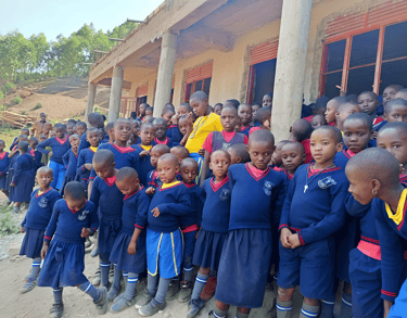 a group of children standing in front of a building