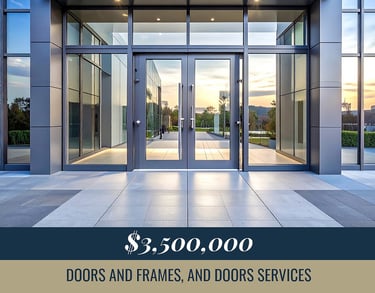 Modern glass storefront entrance with grey aluminum frames and stone tile walkway.