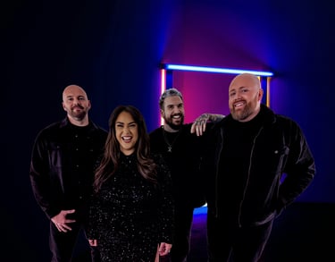 a group of people standing in front of a neon - lit room