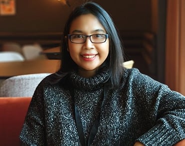 a woman sitting on a couch in a room