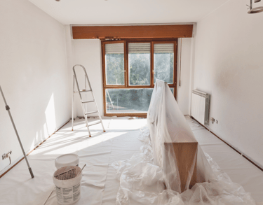 a room with a large window and a ladder