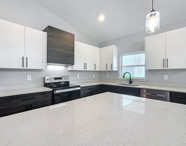 Modern kitchen renovation with quartz countertops, shaker cabinets, and recessed lighting installed 
