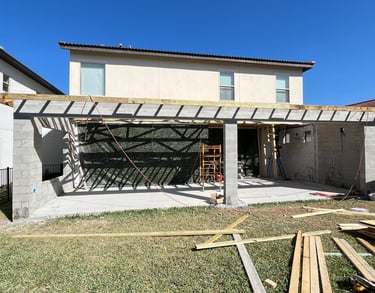 Porch renovation project including new columns, concrete flooring, and weather-resistant finishes fo