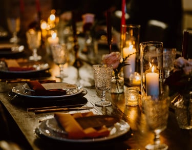 tablescape at chapel and cellar in winter park moody romantic with candles roses black chargers