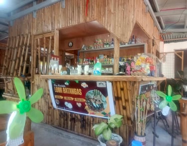 Rustic bamboo restaurant counter in the Philippines advertising authentic Lomi Batangas noodle soup.