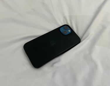 iPhone 13 with black case and a phone wallpaper of a girl 