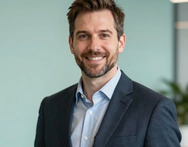 Professional headshot of a male program director in a clean, modern North American / Michigan US office. Deep Forest and Soft Mint background colors.