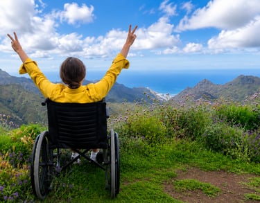 Wheelchair user enjoying an accessible mountain viewpoint.