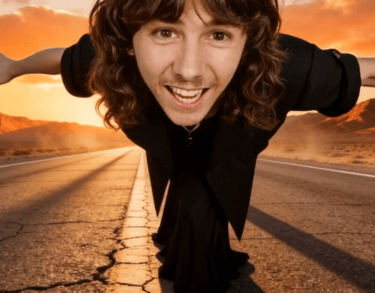 Smiling man with long hair Jimi Nix posing on a desert road at sunset with arms outstretched.