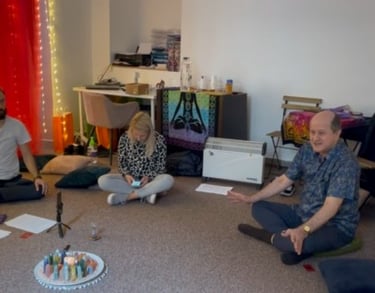 People sitting in a circle during a spiritual meditation session with Eugen Mirtz