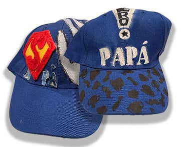 Baseball caps hand decorated by J.N.'s children.