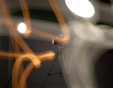 A DSLR camera on a tripod in a studio with creative long exposure light painting effects.
