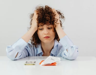 a woman sitting at a table with a lot of money