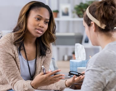 a woman in a chair talking to a woman in a chair