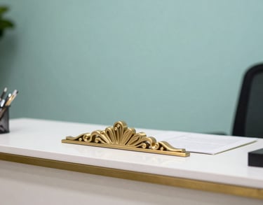 A detail shot of a reception area in a Brazilian health association. A gold-toned decorative element is visible on a clean white desk, with a soft teal backdrop.