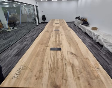 21ft x 4.5ft solid maple boardroom table custom built for Peak Products Canada — installed room view